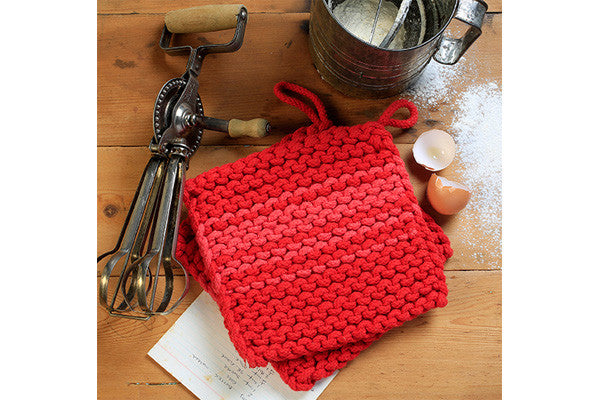 a pair of retrokitchen knitted trivets in red